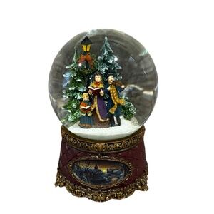 Roma Festive Family Singing Snow Globe with Green, Red & White Details.